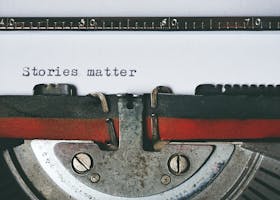 Close-up of a vintage typewriter with the text 'Stories matter' typed on paper, evoking nostalgia.